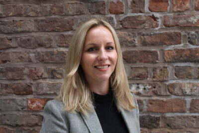 Headshot of Laura Rooney smiling to camera.