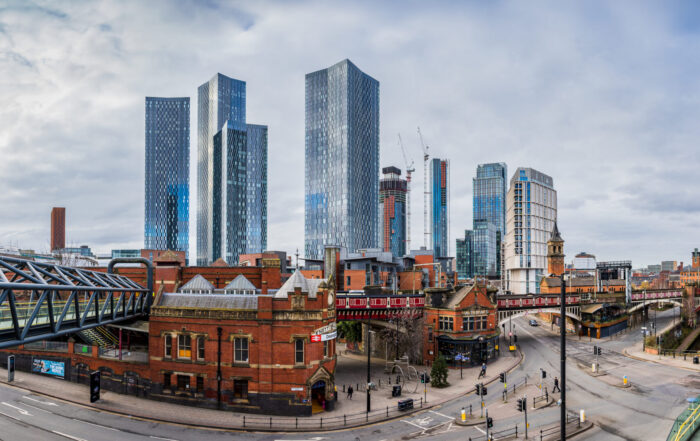 A multi image panorama of Deansgate in Manchester backed by the Deansgate Square skyscraper complex.